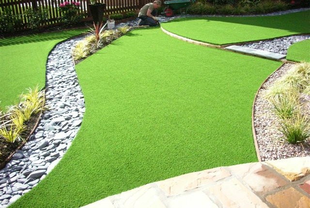 layered custom fitted artificial grass featured garden in Taffs Well